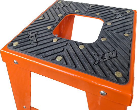 Orange step stool with textured black platform on a white background